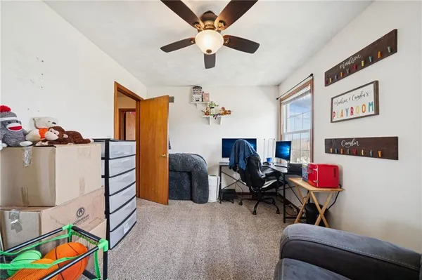 a bedroom with furniture and a workspace