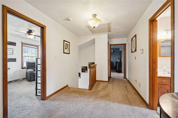 a view of a hallway with bathroom and glass door