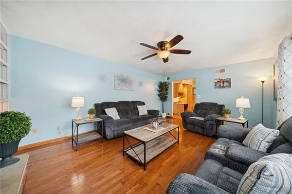 a living room with furniture and wooden floor