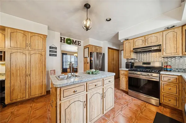 a kitchen with stainless steel appliances granite countertop a stove and a sink