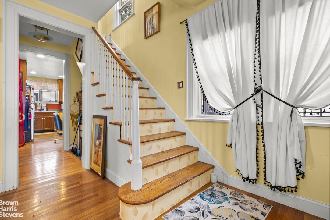 112-14 178th Street Queens, NY 11433 - Photo 11 of 24 a view of entryway with wooden floor and stairs
