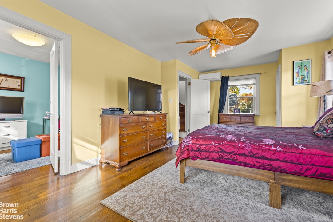 112-14 178th Street Queens, NY 11433 - Photo 14 of 24 a bedroom with a bed and wooden floor