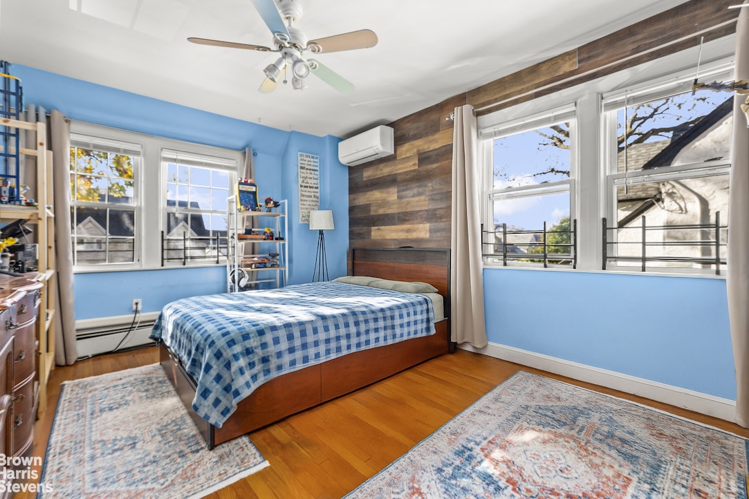 112-14 178th Street Queens, NY 11433 - Photo 16 of 24 a bedroom with a large bed and a window