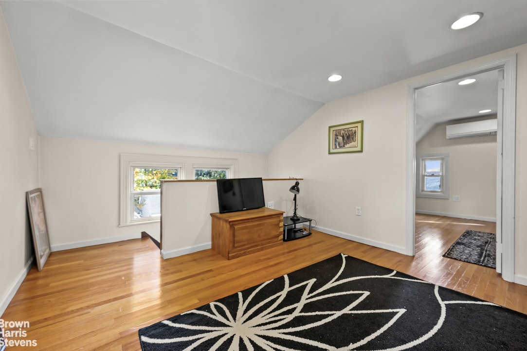 112-14 178th Street Queens, NY 11433 - Photo 17 of 24 a room with wooden floor and ceiling fan
