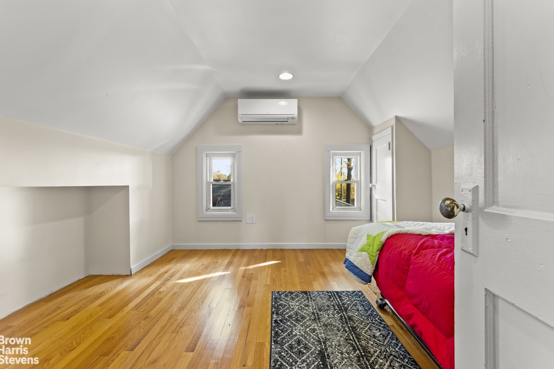 112-14 178th Street Queens, NY 11433 - Photo 18 of 24 a bed room with a bed and a couch