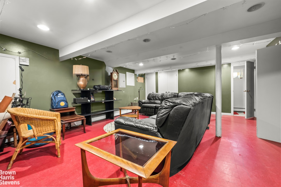 112-14 178th Street Queens, NY 11433 - Photo 19 of 24 a living room with furniture a rug kitchen view and a table