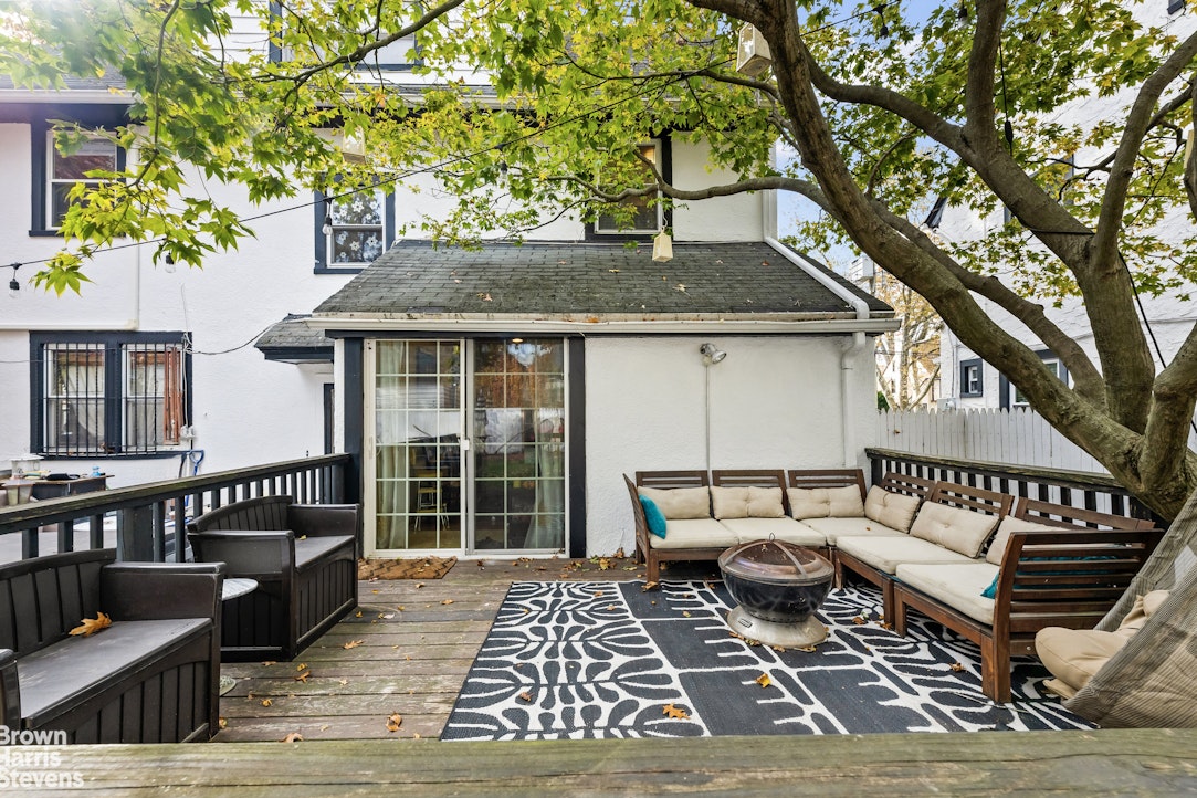112-14 178th Street Queens, NY 11433 - Photo 20 of 24 a view of a house with wooden deck and furniture