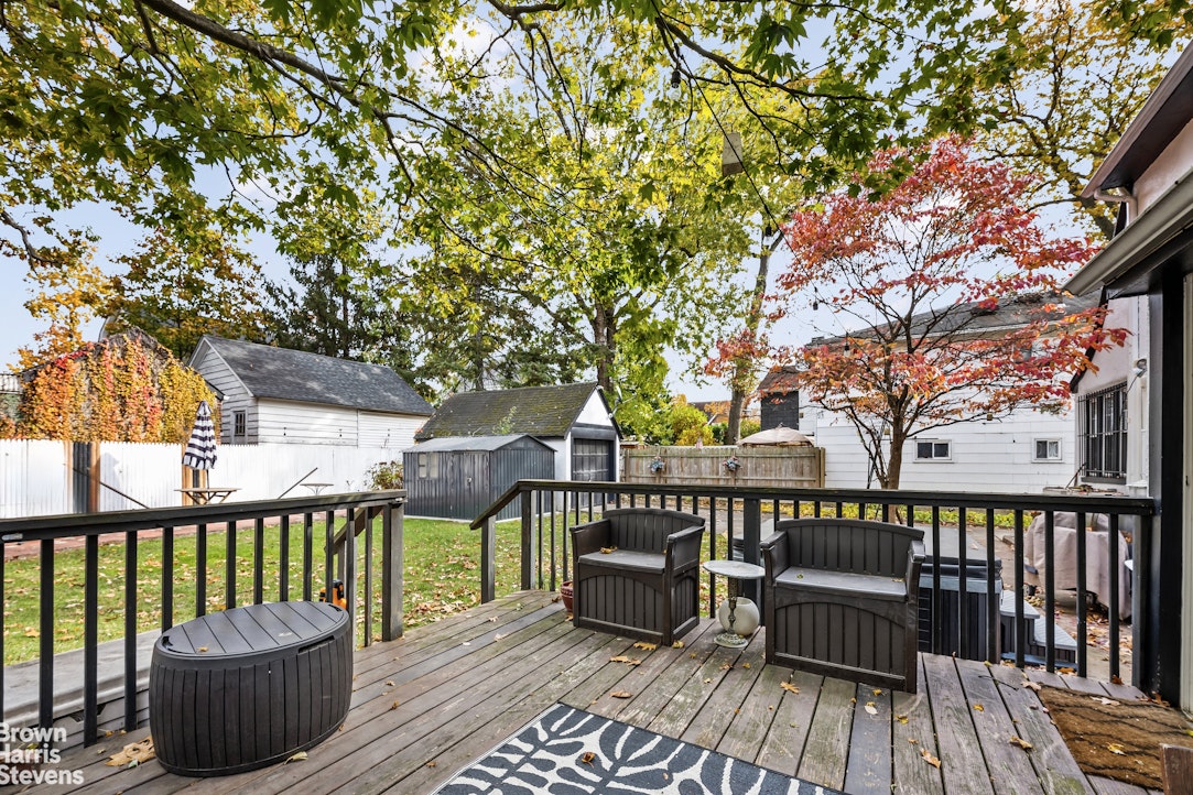 112-14 178th Street Queens, NY 11433 - Photo 22 of 24 a view of a deck with chairs and wooden fence