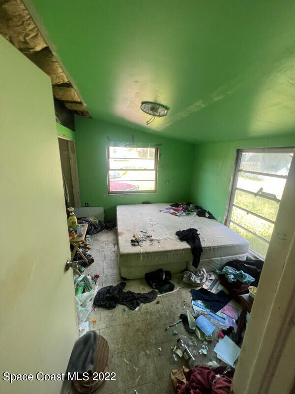 342 Gray Road Melbourne, FL 32904 - Photo 3 of 6 a workspace with furniture and a window