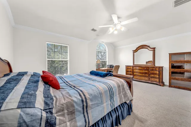 a bedroom with a bed and a chandelier