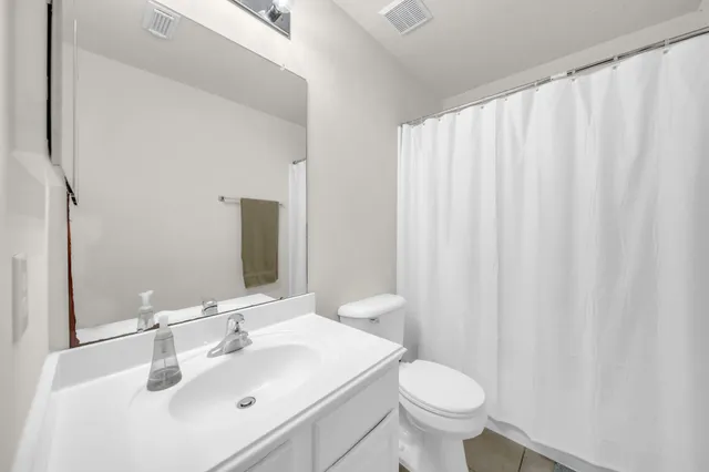 a bathroom with a sink toilet and mirror