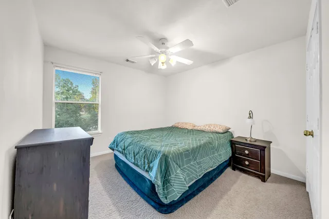 a bed sitting in a bedroom next to a window