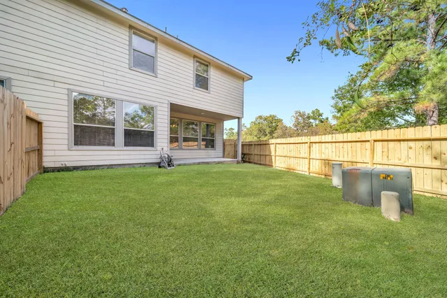 a view of a house with a backyard