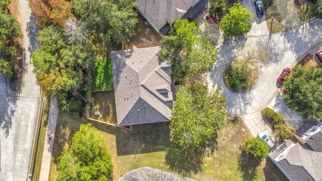 an aerial view of a house with a yard