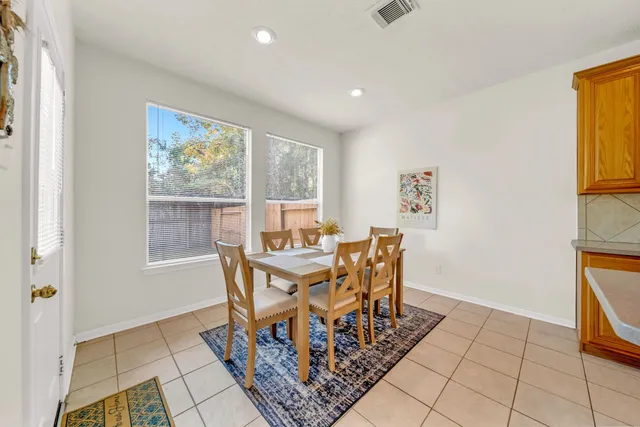 a dining room with furniture and a floor to ceiling window