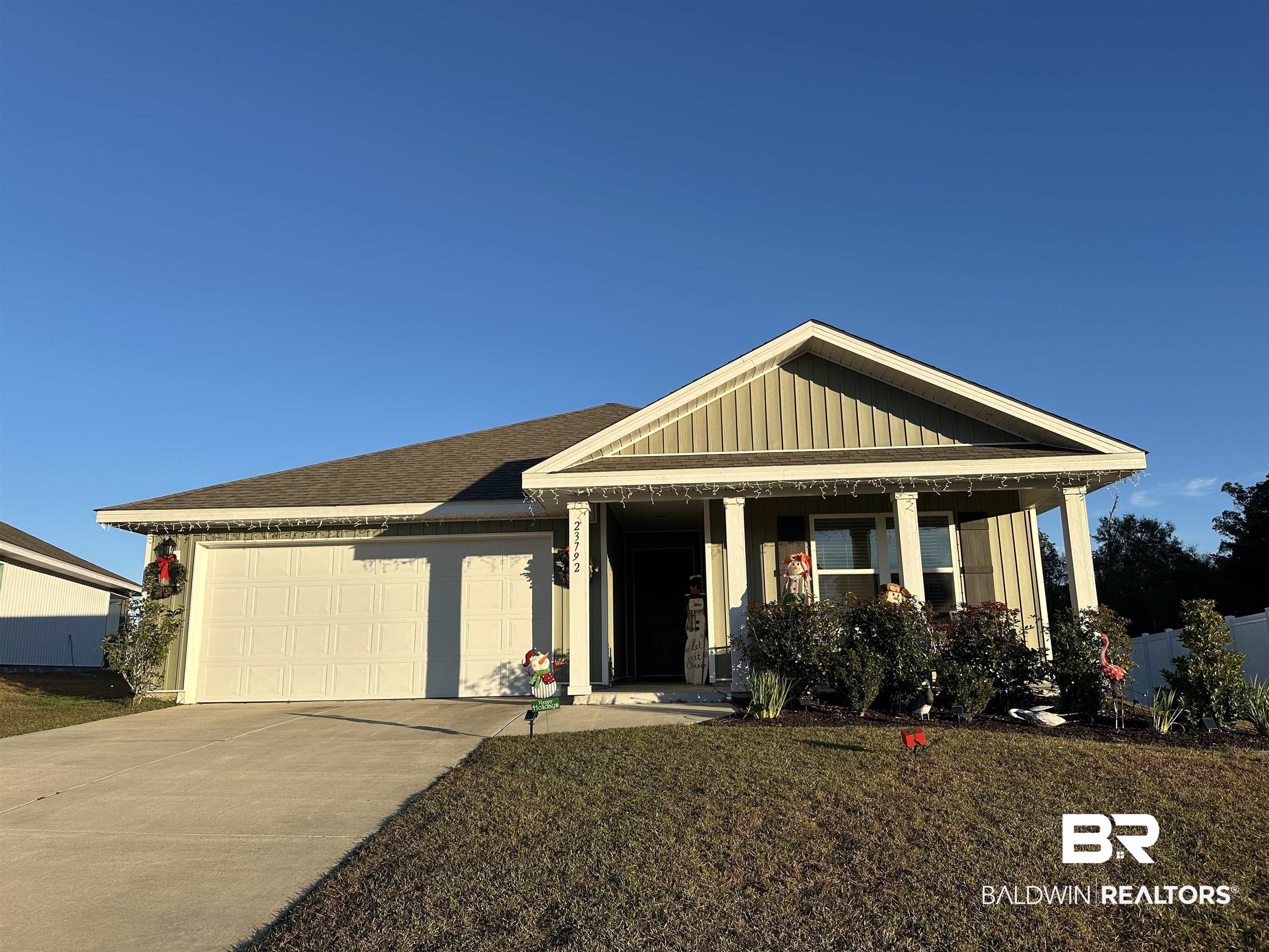 23792 Unbridled Loop Daphne, AL 36526 - Photo 2 of 36 View of front of home featuring a porch, board and batten siding, driveway, a shingled roof, and an attached garage
