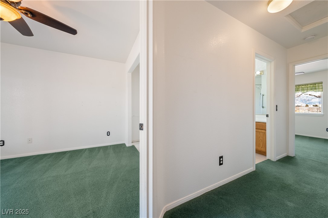 3581 Ranger Way Pahrump, NV 89048 - Photo 35 of 57 3rd bedroom with dark carpet, attic access, and baseboards