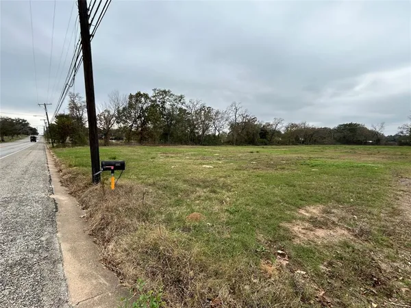 a view of a field with an trees