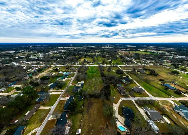 a view of a field with an ocean view