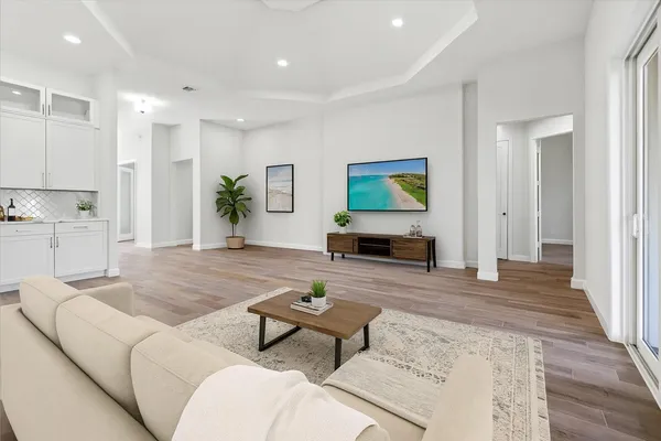 a living room with furniture and a wooden floor
