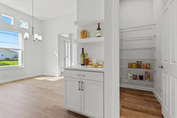 a view of kitchen with livingroom and wooden floor