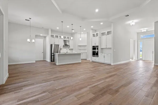 a view of kitchen with kitchen island and stainless steel appliances