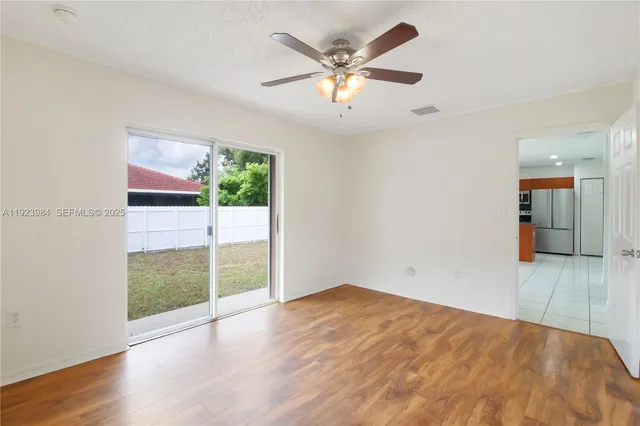 an aerial view of a house with a yard and a large tree
