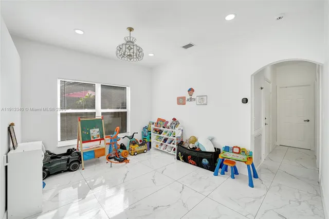 a view of a room with toys and a chandelier