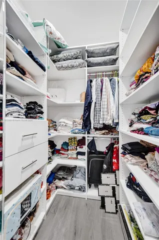 a view of a workspace with furniture and wooden floor