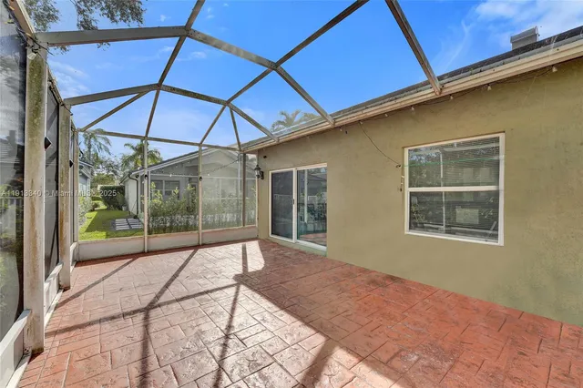 a view of a house with a big yard plants and large trees