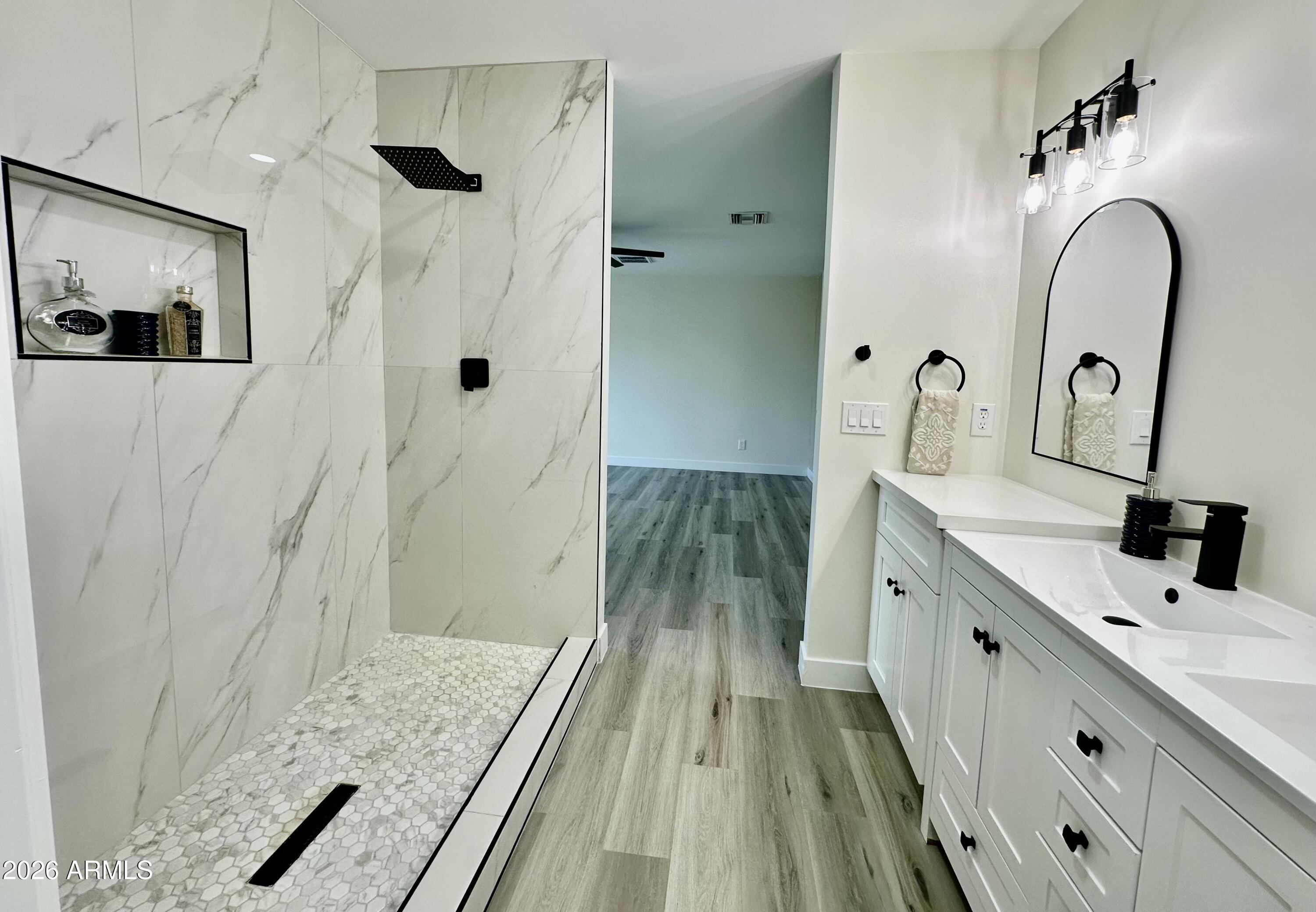 5236 South 19th Avenue Phoenix, AZ 85041 - Photo 16 of 47 a bathroom with a double vanity sink and a mirror