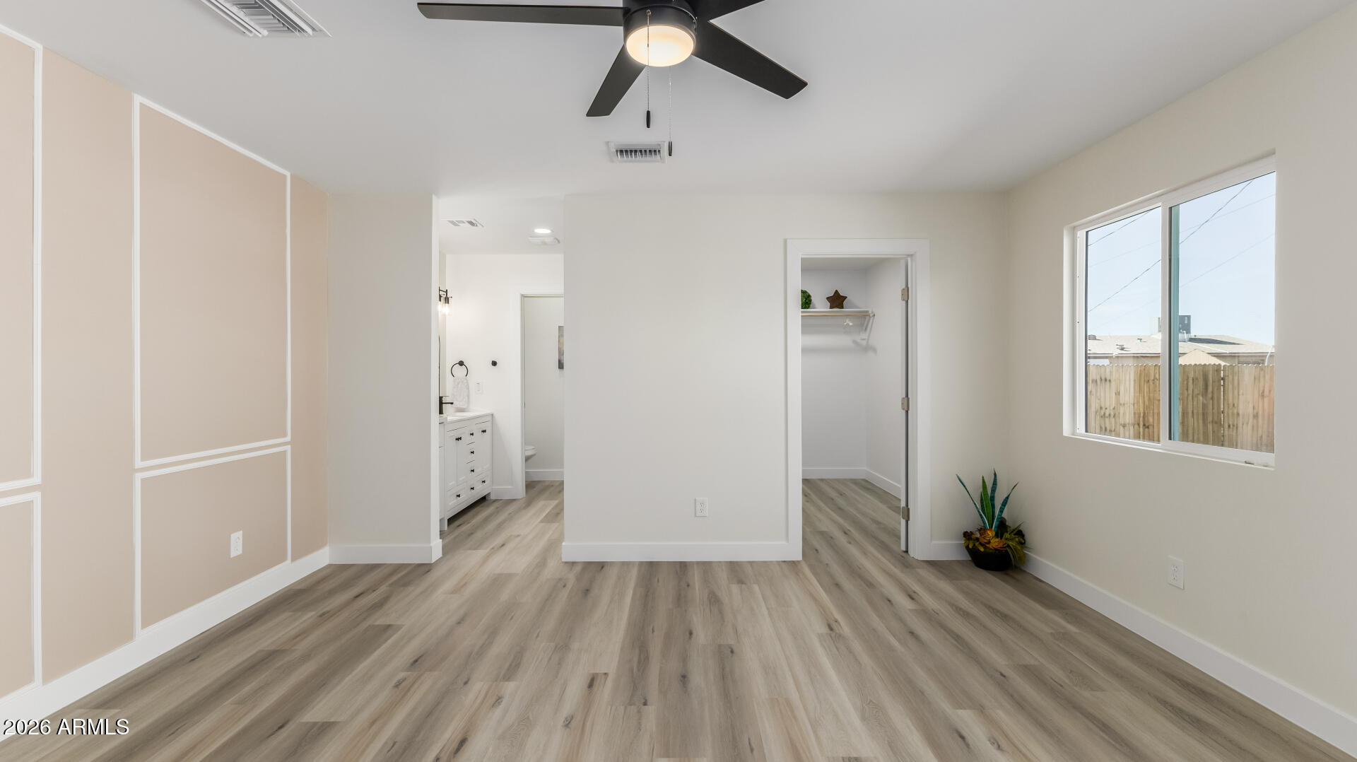 5236 South 19th Avenue Phoenix, AZ 85041 - Photo 20 of 47 a view of empty room with wooden floor and fan