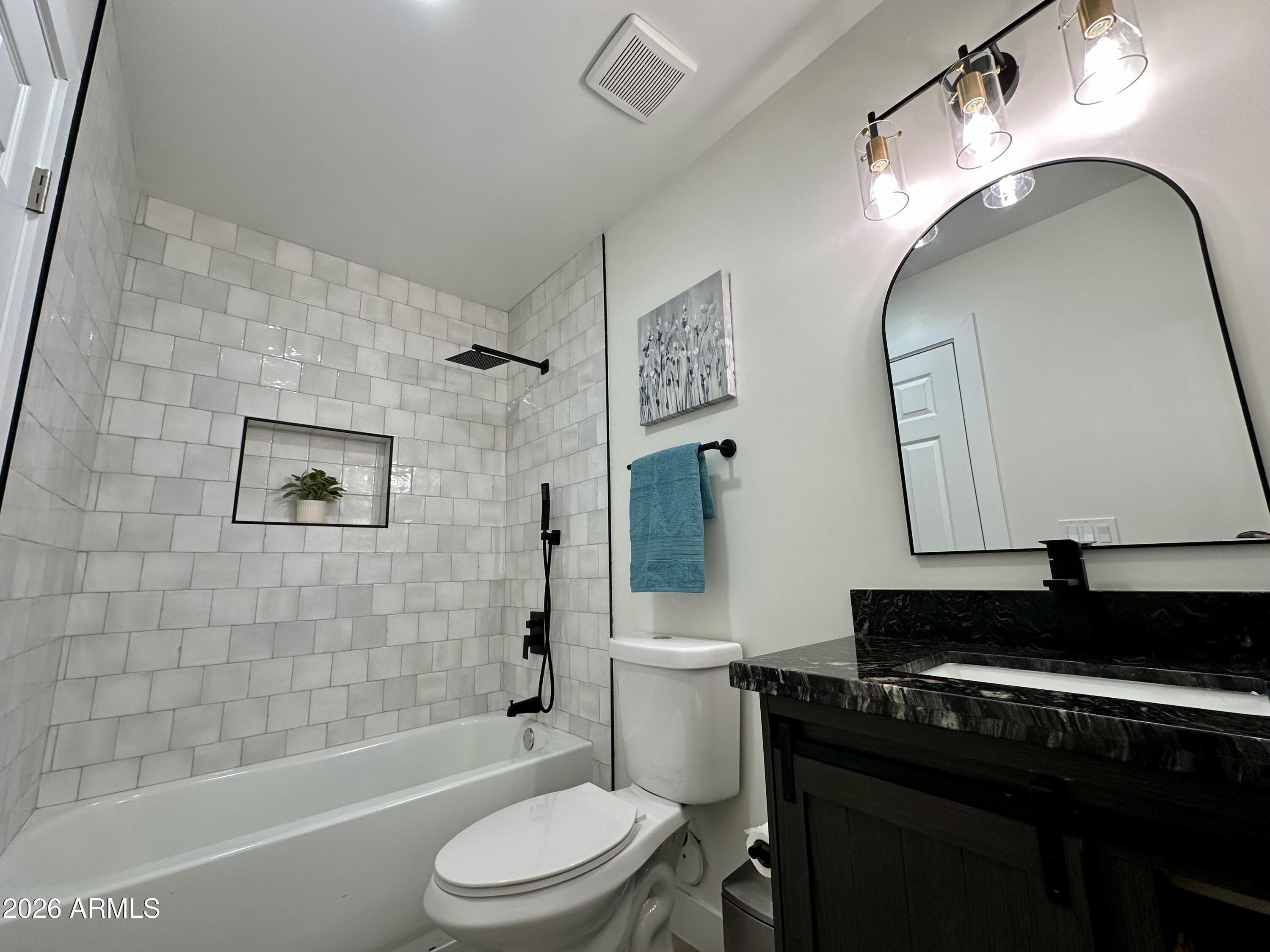 5236 South 19th Avenue Phoenix, AZ 85041 - Photo 32 of 47 a bathroom with a toilet sink vanity granite shower and bathtub