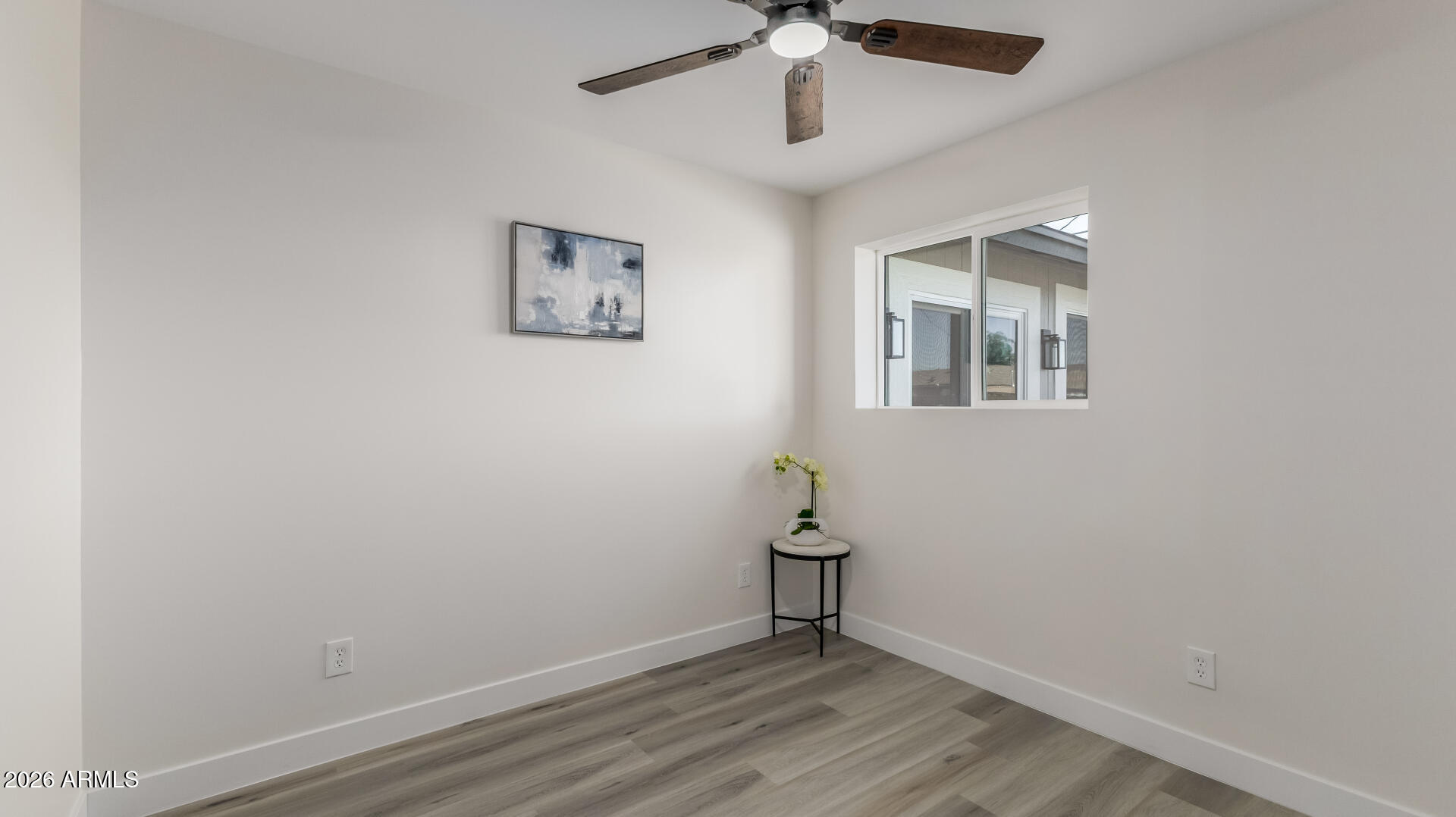 5236 South 19th Avenue Phoenix, AZ 85041 - Photo 34 of 47 an empty room with a window and a ceiling fan