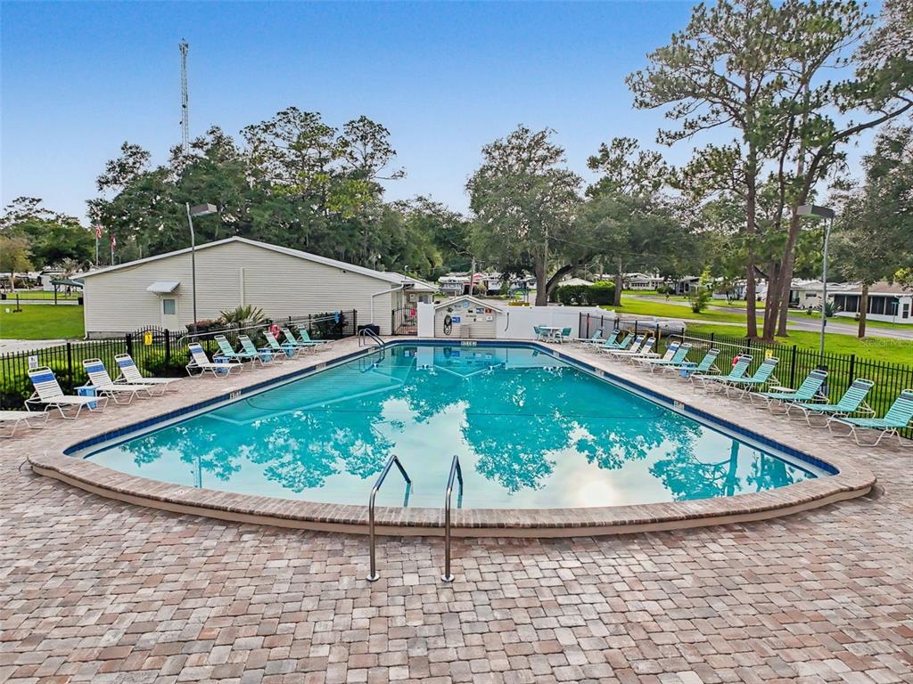 2092 Culbreath Road, Unit A42 Brooksville, FL 34602 - Photo 40 of 70 a view of a swimming pool with a patio and a garden