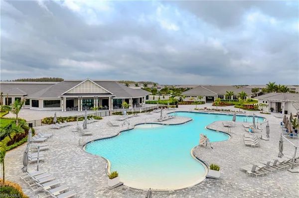 an aerial view of a house with swimming pool patio and outdoor seating