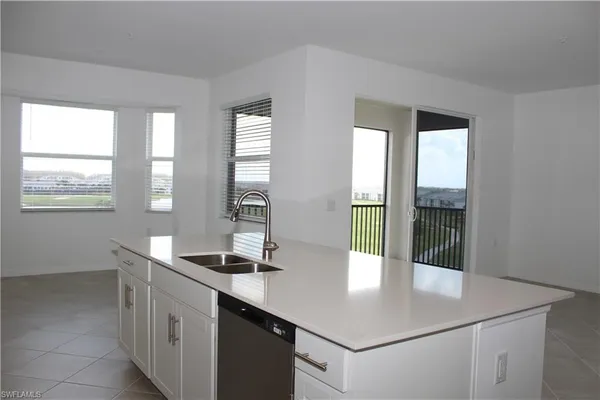 a kitchen with a sink and large window