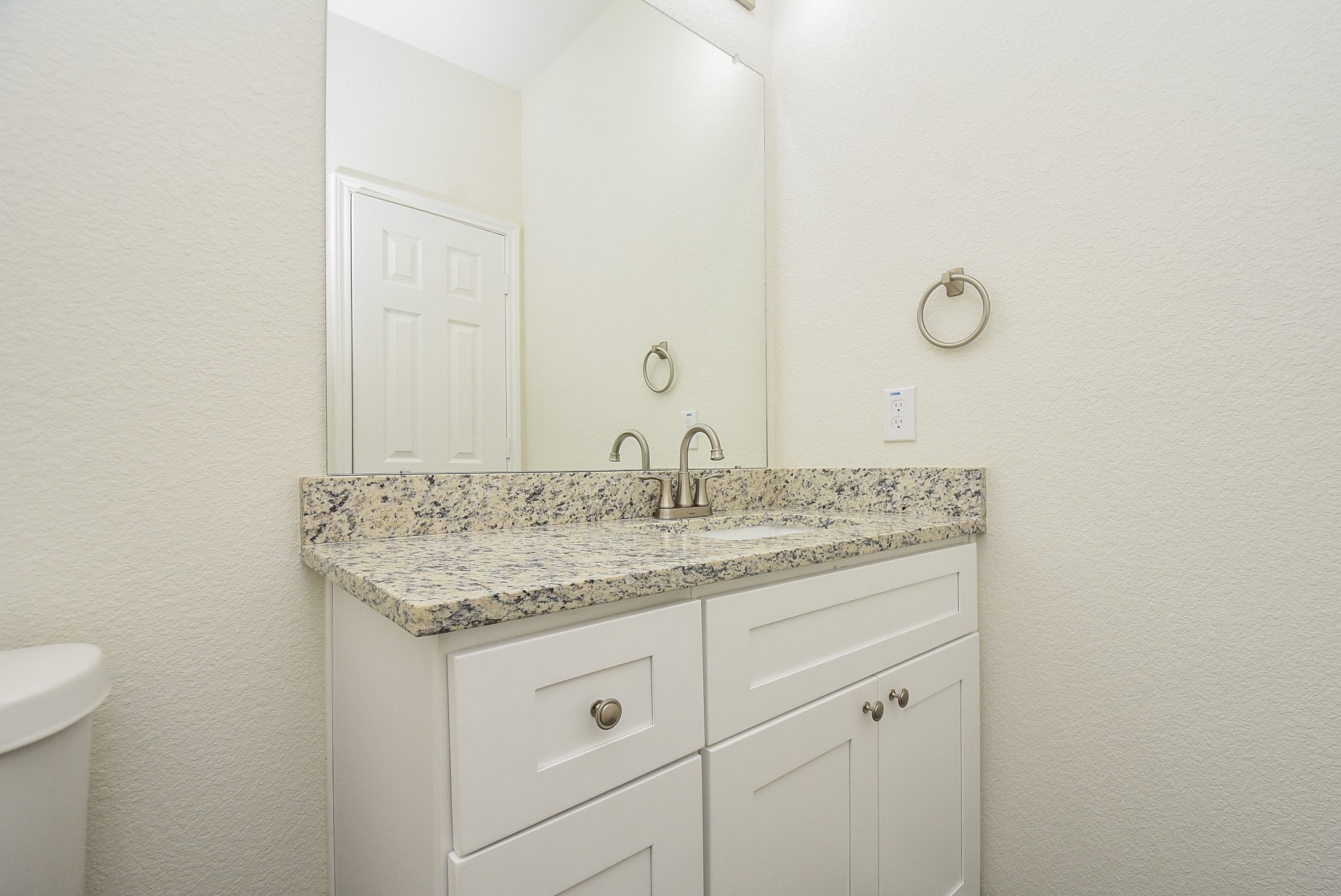 2811 Topiary Lane Houston, TX 77014 - Photo 15 of 32 a bathroom with a granite countertop sink and a mirror