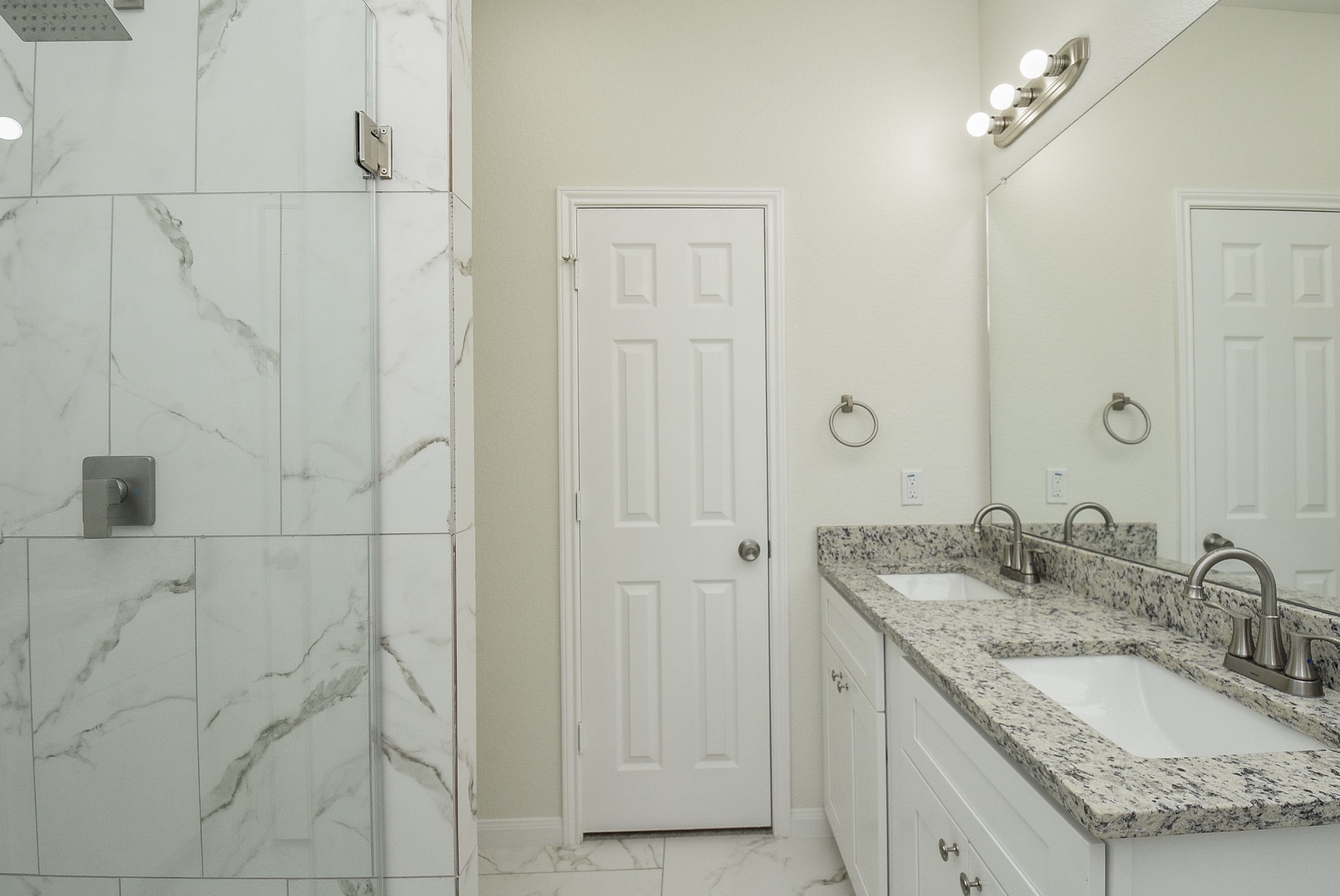 2811 Topiary Lane Houston, TX 77014 - Photo 19 of 32 a bathroom with a granite countertop sink a mirror and shower