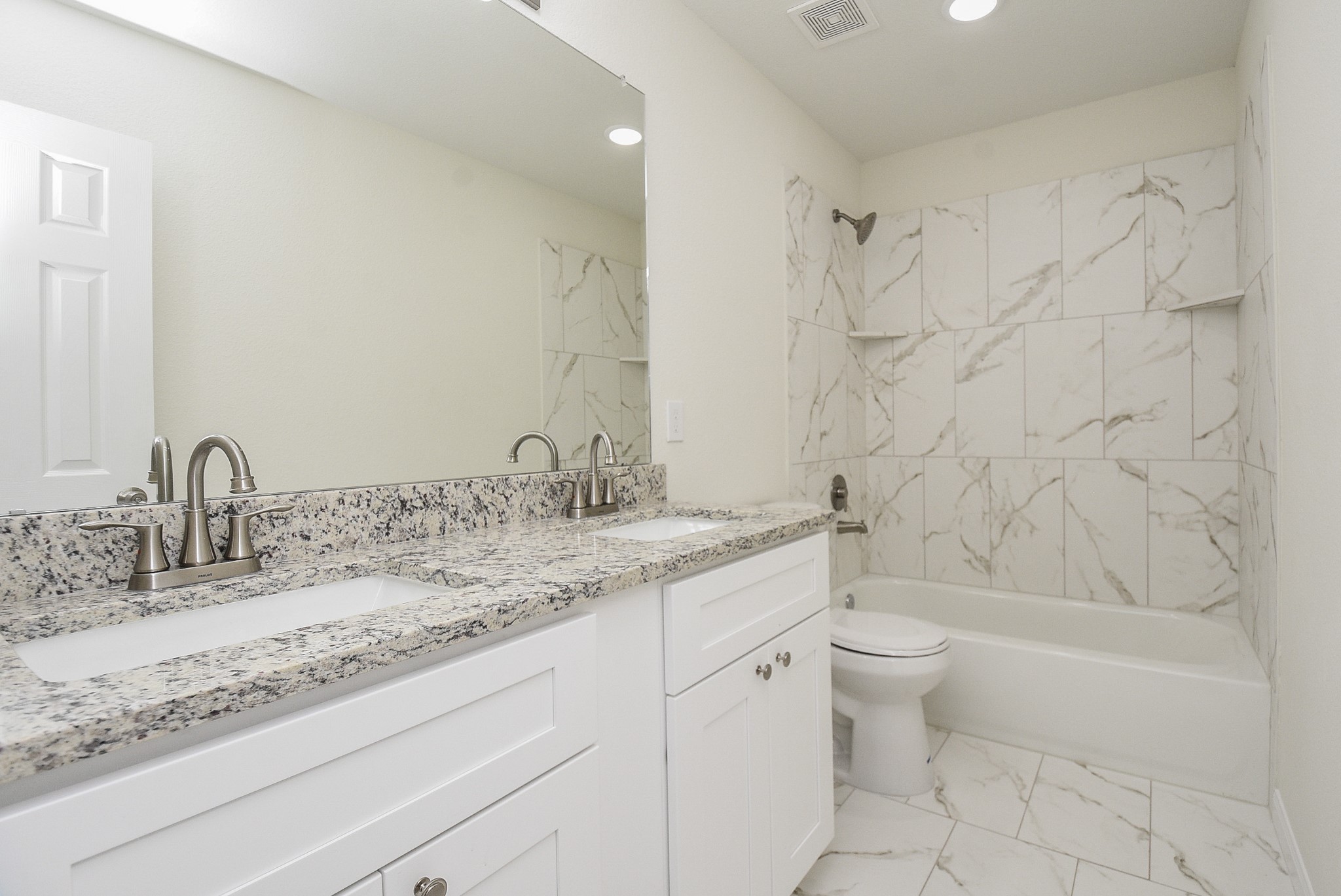 2811 Topiary Lane Houston, TX 77014 - Photo 28 of 32 a bathroom with a granite countertop sink a toilet and bathtub