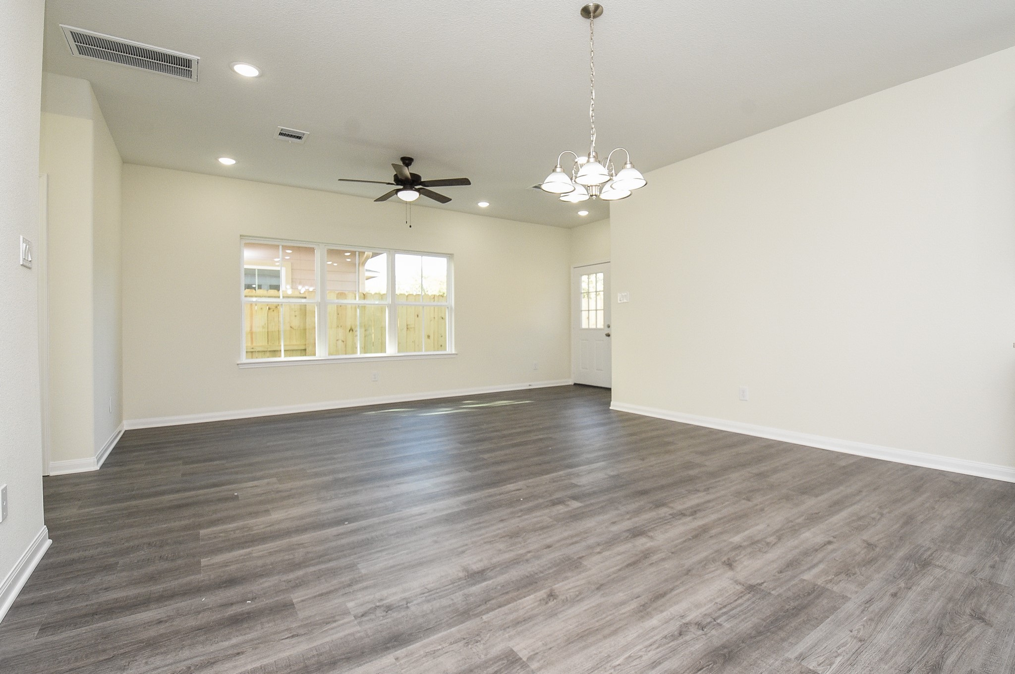 2811 Topiary Lane Houston, TX 77014 - Photo 8 of 32 wooden floor in an empty room with a window