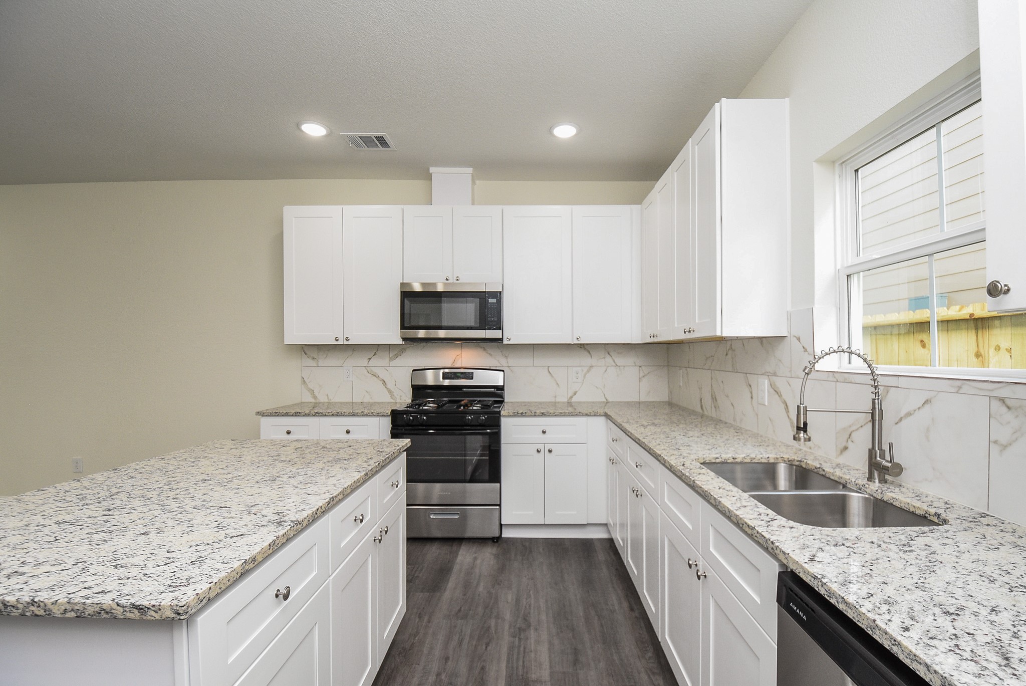 2811 Topiary Lane Houston, TX 77014 - Photo 10 of 32 a kitchen with stainless steel appliances granite countertop a sink stove and refrigerator
