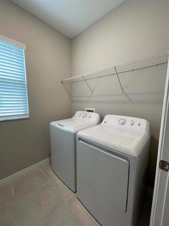 31993 Blue Passing Loop Wesley Chapel, FL 33545 - Photo 7 of 17 a utility room with dryer and washer