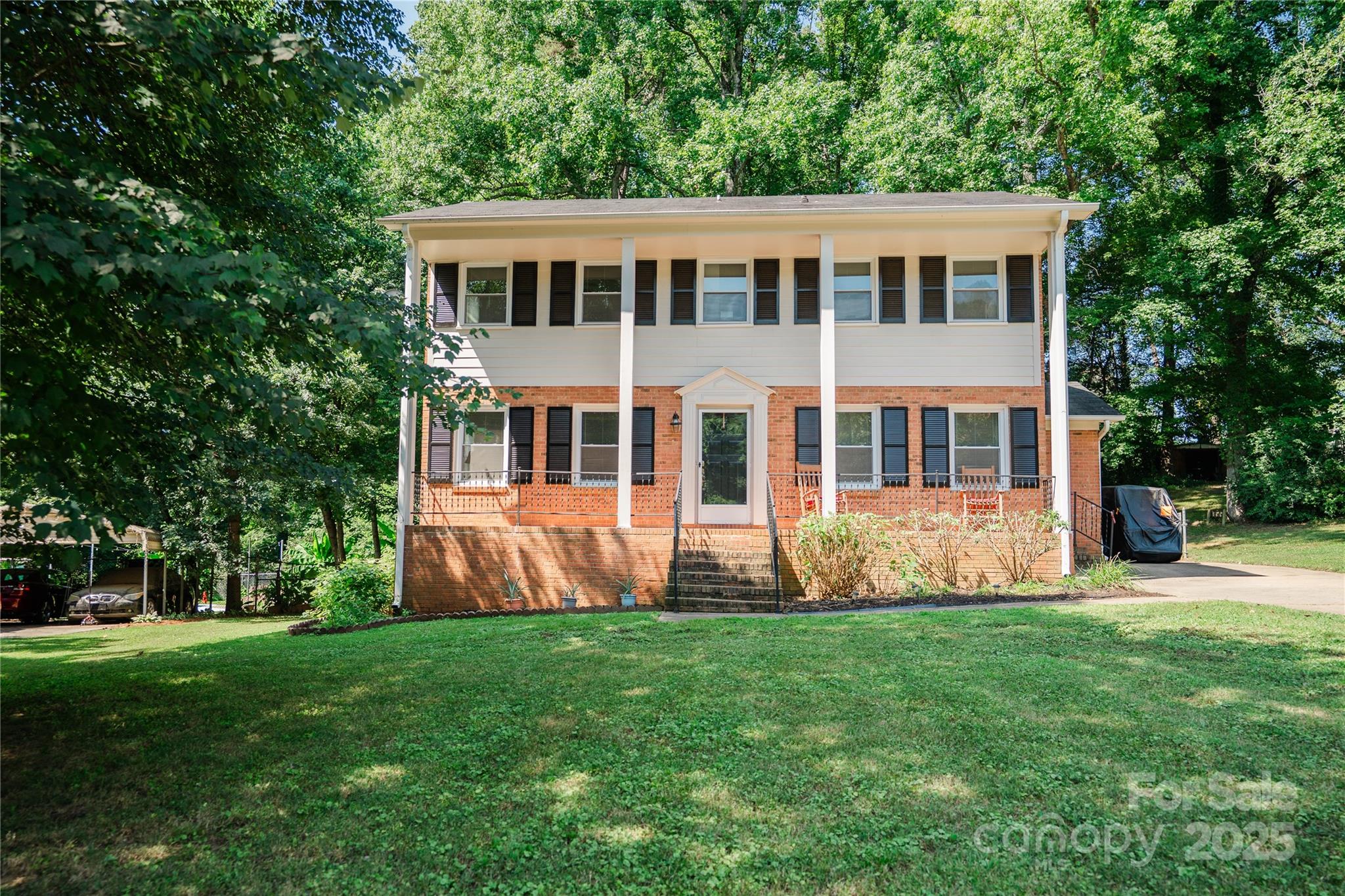 a front view of house with yard and green space