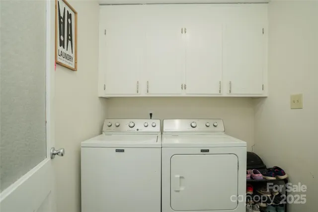 a view of storage and utility room with washer and dryer