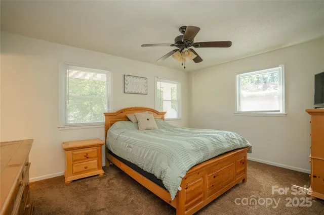 a bed sitting in a bedroom next to a window