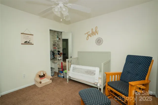 a bedroom with a bed and the couch