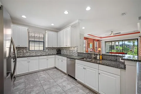 a kitchen with granite countertop a sink and cabinets