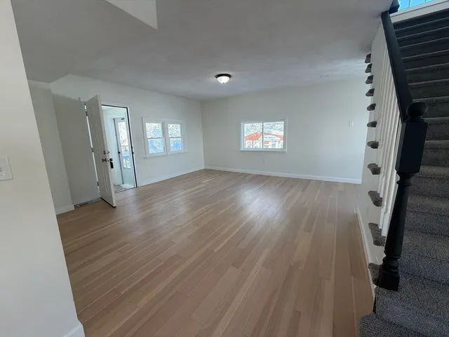 a view of a kitchen with a sink and a refrigerator