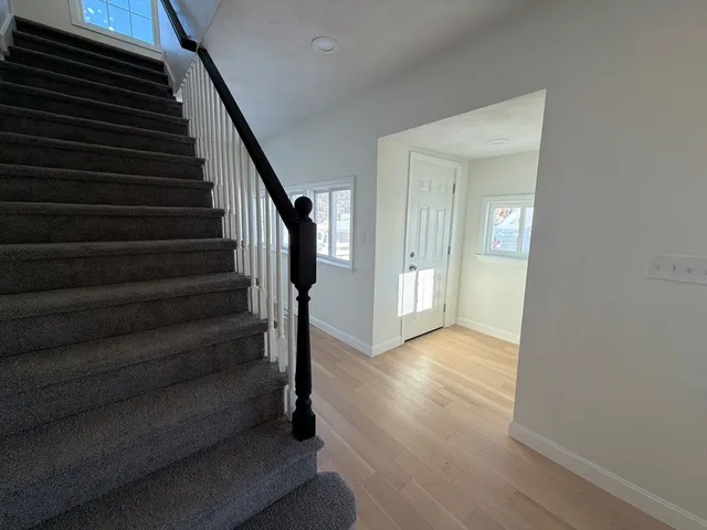a large kitchen with stainless steel appliances granite countertop a stove and a refrigerator
